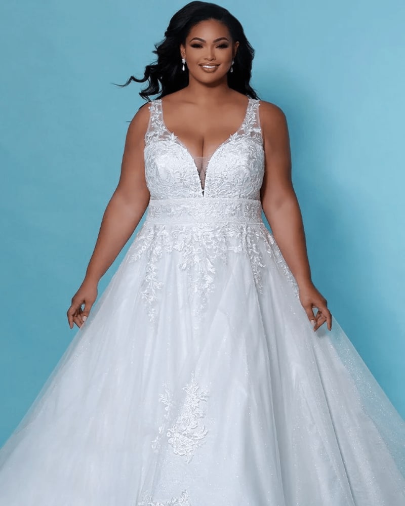 Front of a model wearing a size 26 Hazel Wedding Dress in Ivory by Sydney's Closet. | dia_product_style_image_id:285881